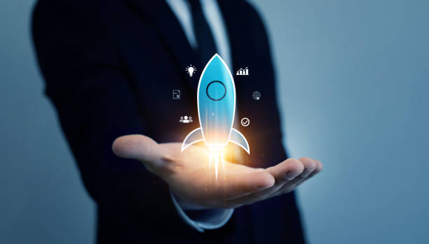 istock Startup target business and goals development concept. Businessman holding virtual rocket launch. 2174660184