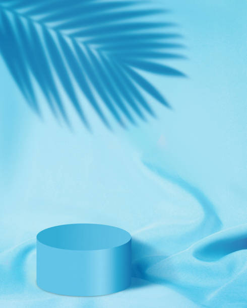 Blue cosmetic podium with fabric and leaf shadow background
