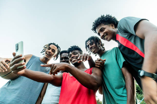 istock Young athlete friends men using mobile phone outdoors 2174662582