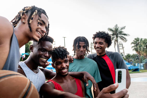 istock Young athlete friends men using mobile phone outdoors 2174662585