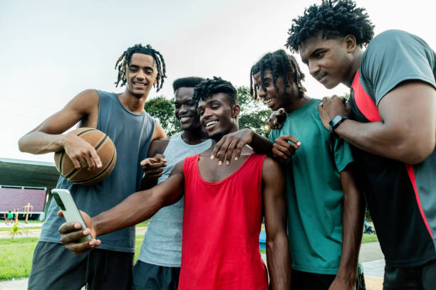 istock Young athlete friends men using mobile phone outdoors 2174662586