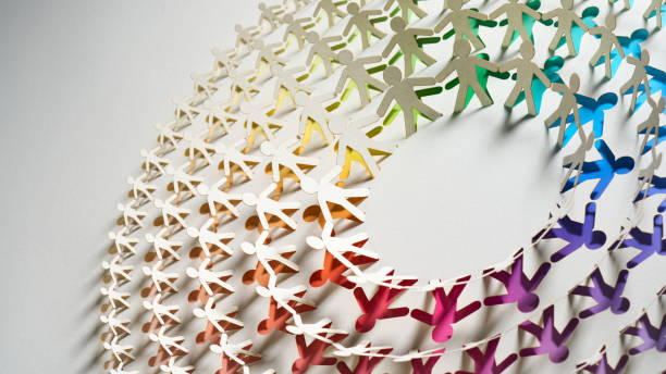 istock Intricate cut paper artwork of interconnected human figures in a circular pattern with a rainbow gradient effect. 2174663744