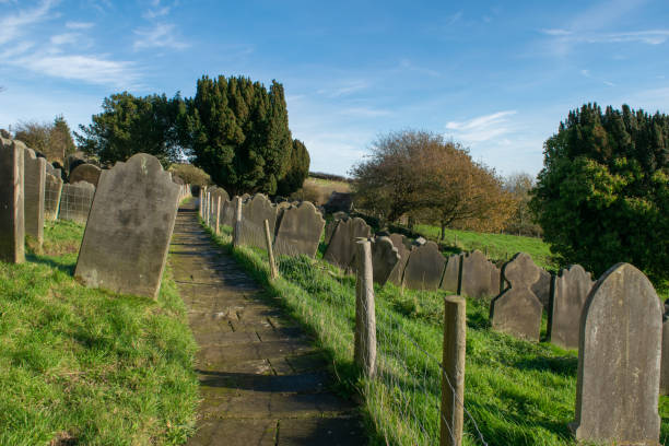 istock Trail with fence next to ancient gravestones in Yorkshire England 2174665036