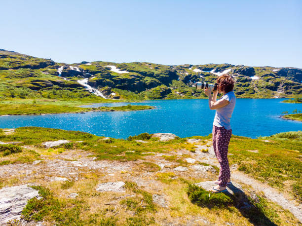 Tourist taking photo in norwegian nature