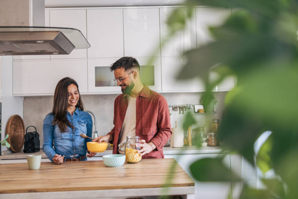 istock An adult cheerful couple having breakfast in the kitchen. 2174672467