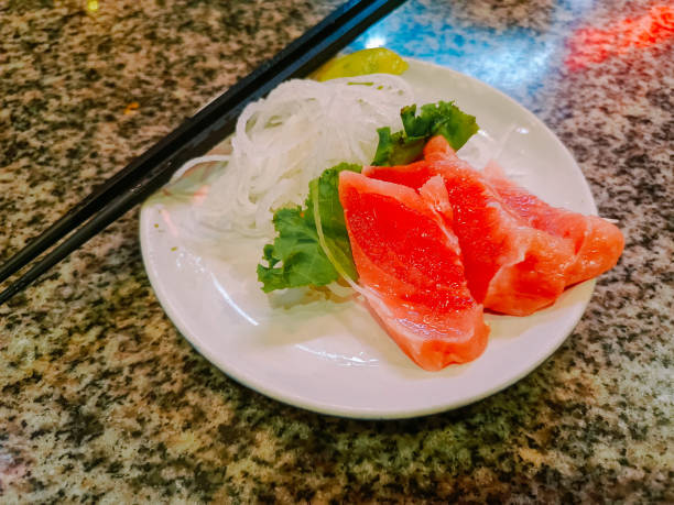 istock salmon sashimi with vegetables and grated fruit like vermicelli with lime so it's not fishy 2174673626