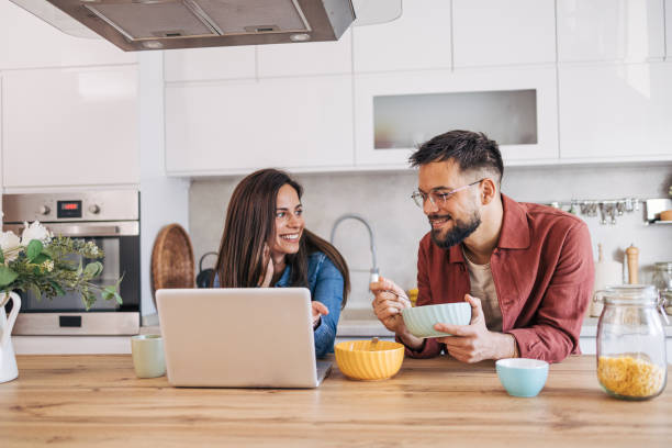 istock An adult cheerful couple having breakfast in the kitchen. 2174674032