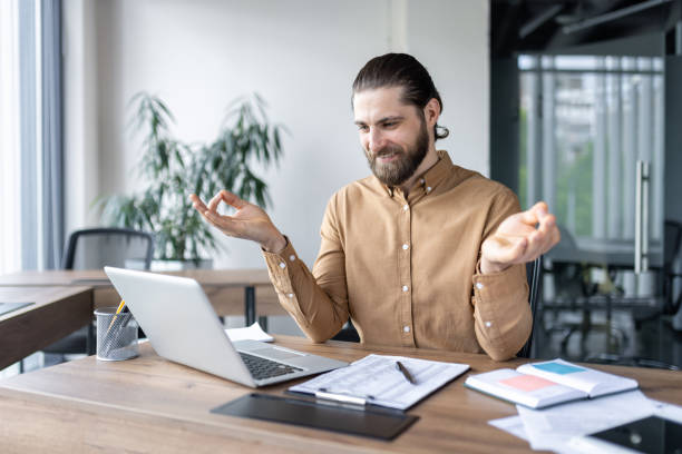 istock Calm businessman practicing relaxation techniques at work while sitting at desk with laptop and documents in modern office. 2174675693