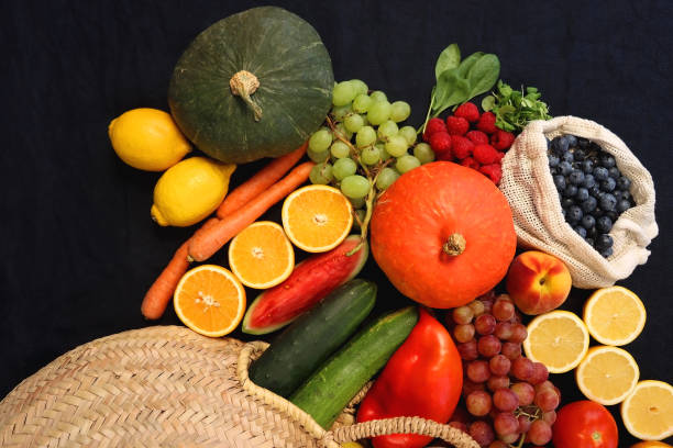 istock Straw Bag And Healthy Produce On Dark Background 2174680573