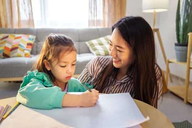 istock Mother and daughter drawing together at home 2174680914