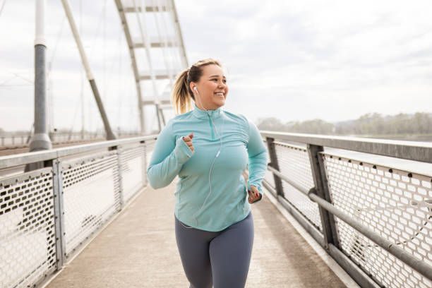 istock Overweight Woman Running 2174681360