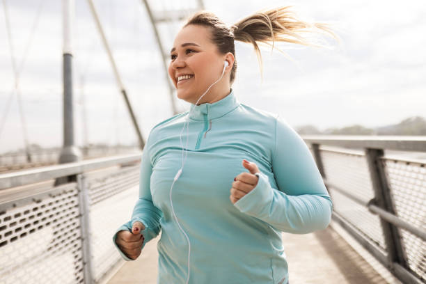 istock Overweight Woman Running on the Bridge 2174681364