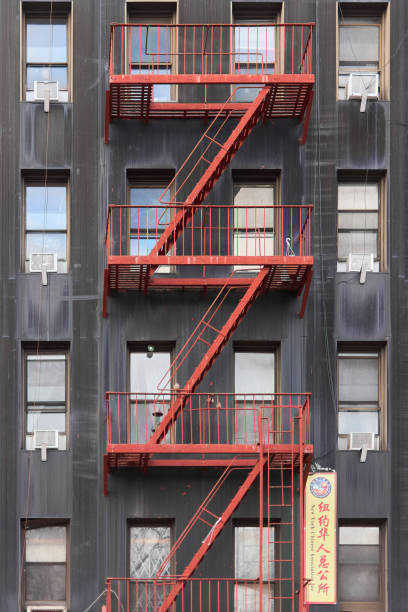 Delancey Street, Manhattan, New York, United States - January 3rd 2025:  New York fire truck with a ladder parked in the street seen through a window