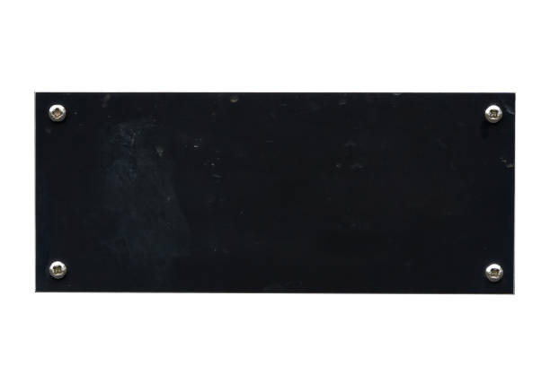 istock Distressed black steel plaque with a painted texture and screws cut out and isolated on a white background 2174682407