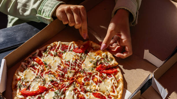 Pizza. Hawaiian Pizza. Pineapple Pizza. Pizza with pineapple, ham, onions, cheese, tomatoes, bacon, and sauce.
