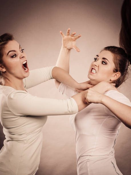 Two agressive women having argue fight being mad at each other. Female violance concept.