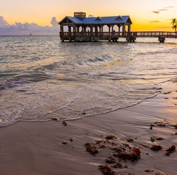 istock Tourists Watching Sunset From Wooden Pavilion on Hidden Beach 2174688917
