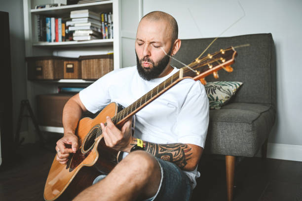 istock man plays the guitar and sings songs 2174689120