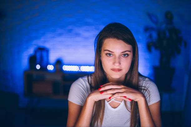 Young woman working late at night in her home office