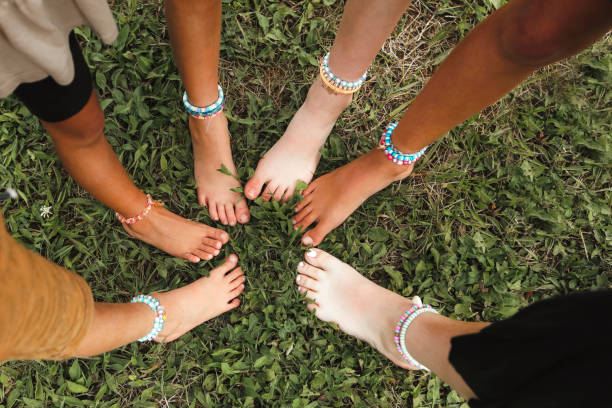 istock Children's Barefeet with Ankle Bracelets 2174692639