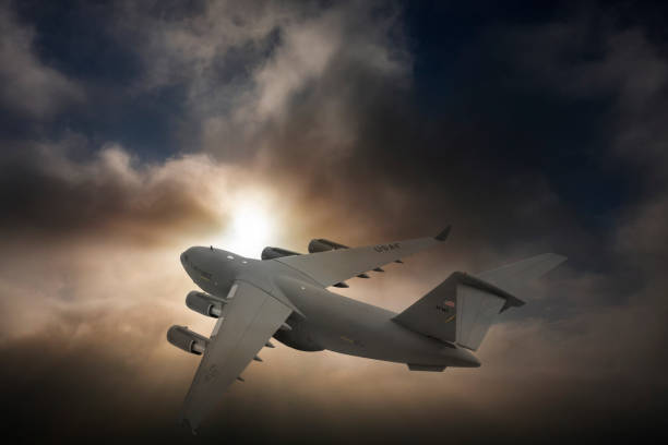 istock US Air Force  C-17 Globemaster III transport aircraft. Flying over clouds. 2174693538