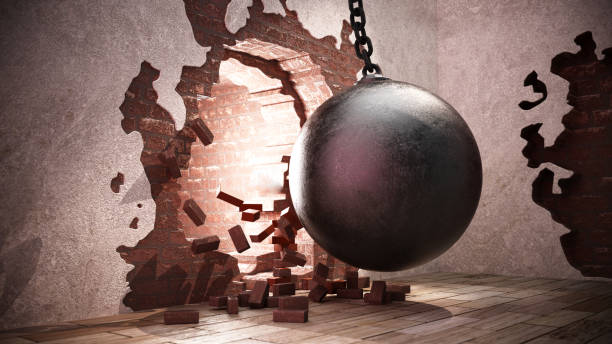 istock A large wrecking ball breaking through a brick wall, creating debris on the floor in an urban renovation setting 2174697921