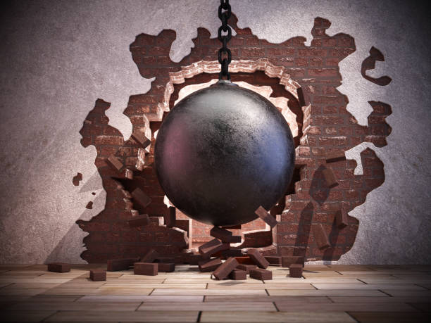 istock A large wrecking ball breaking through a brick wall, creating debris on the floor in an urban renovation setting 2174697957