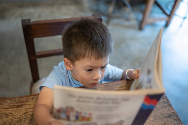 istock Focused child reading a book with intense curiosity 2174699517