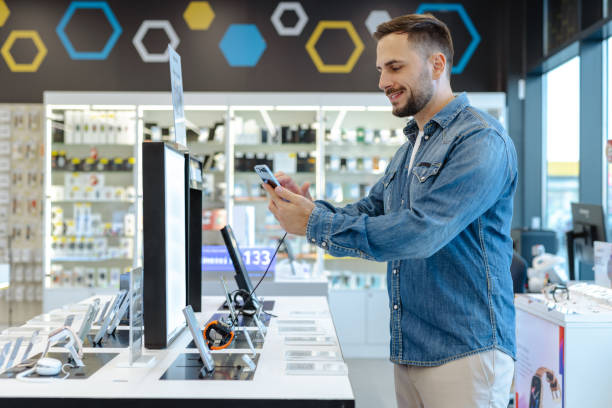 istock Man shopping for a new smartphone in an electronics store 2174699616
