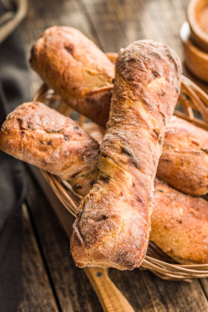 istock Crusty rustic baguette in basket  on wooden table. 2174700716
