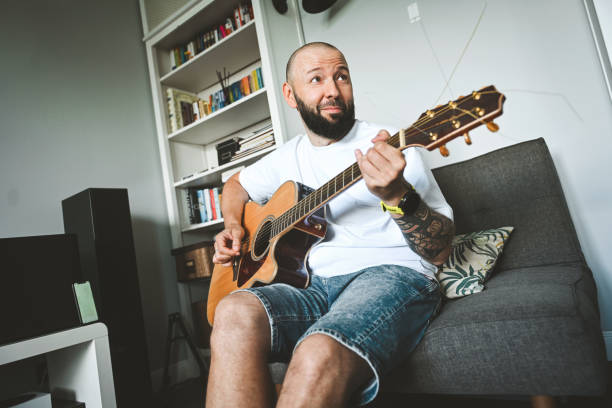 istock man plays the guitar and sings songs 2174703245