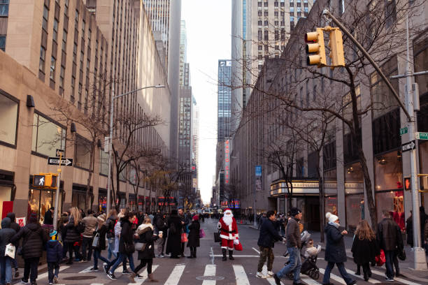 Santa Claus stands on West 50th Street during Christmas time, near Rockefeller Plaza and Radio City Music Hall, in Manhattan, New York City