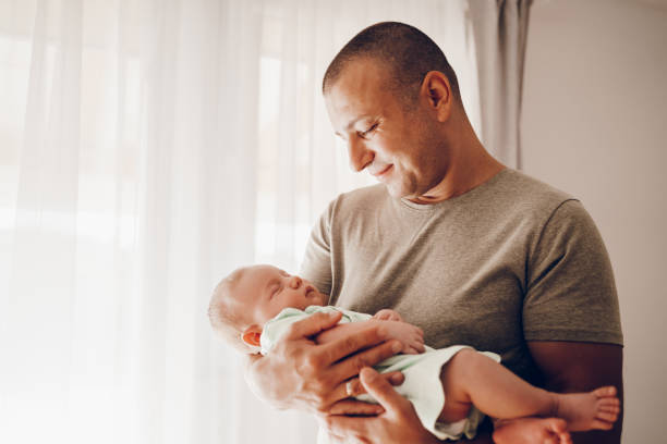 istock Father holding his newborn baby 2174703652