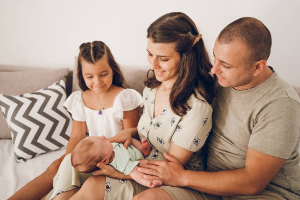 istock Happy family looking at sleeping baby 2174703988