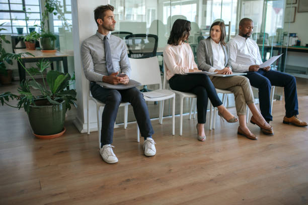 istock Job applicants sitting in an office waiting to be interviewed 2174704015