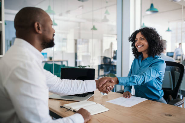 istock Smiling manager shaking hands with an applicant after an interview 2174704374