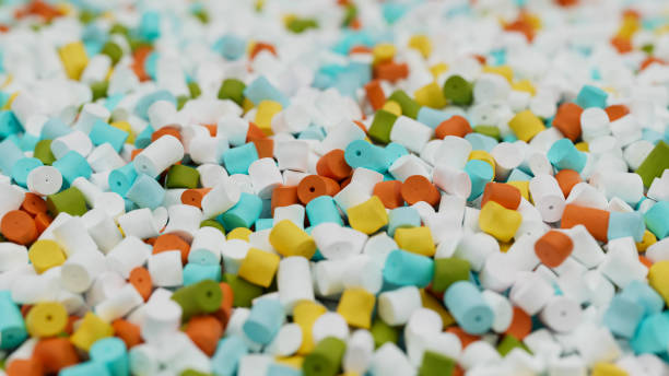 istock Closeup of colorful mix plastic polypropylene granules, masterbatch polymer grain with shallow dof. HDPE or PVC resin pellets. 3d render illustration 2174705885