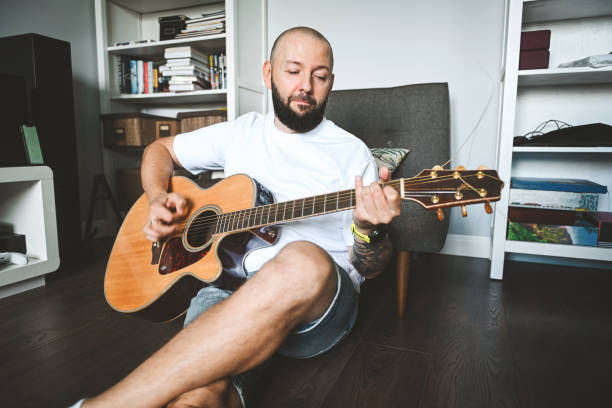 istock man plays the guitar and sings songs 2174706791