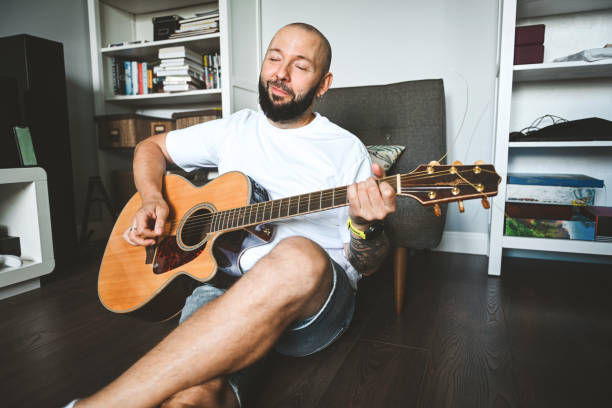 istock man plays the guitar and sings songs 2174707158