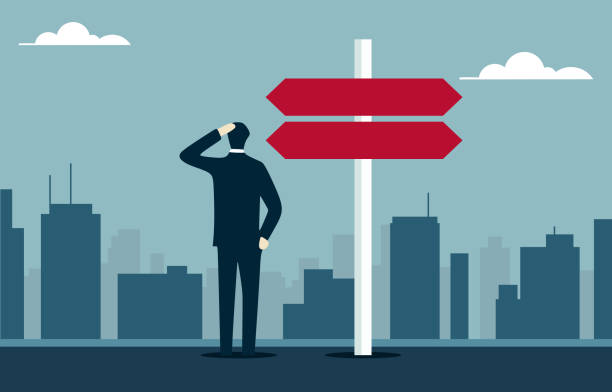 istock Businessman at Crossroads Facing Career Decision in Cityscape 2174710894