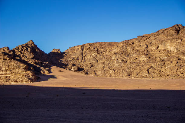 istock Sand Dunes and Rugged Rock Formations in the Jordanian Desert 2174716435