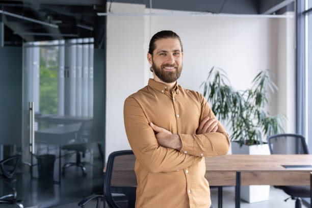 istock Confident businessman smiling in modern office space 2174725563