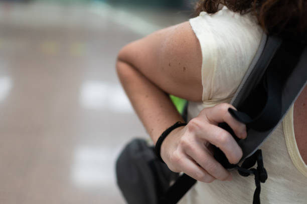 istock Close-up of woman tightening backpack strap while traveling 2174727552