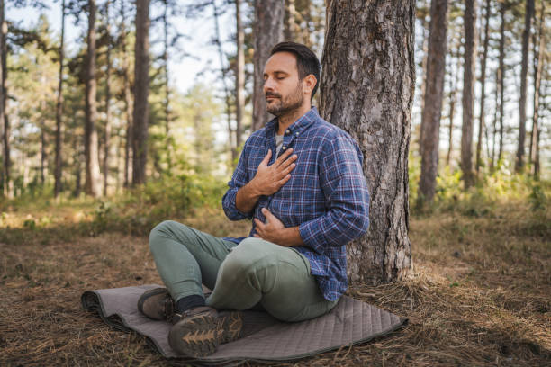 istock Adult man camper practice meditation and breath exercise in front tree 2174731777