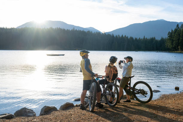 istock Mountain bikers take photo on  lakeshore 2174734700