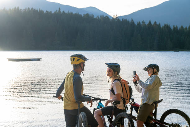 istock Mountain bikers take photo on  lakeshore 2174734819