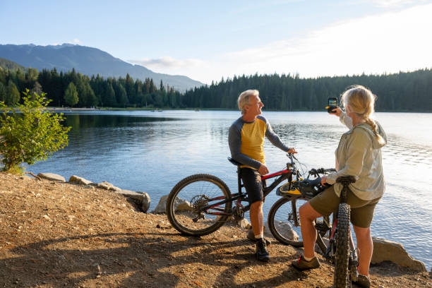 istock Mountain bikers take photo on  lakeshore 2174734820