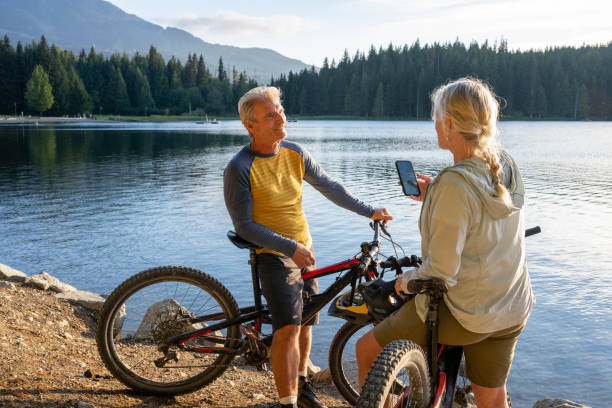 istock Mountain biking couple pause on lakeshore 2174734821