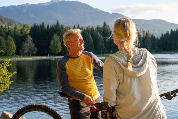 istock Mountain biking couple pause on lakeshore 2174734823