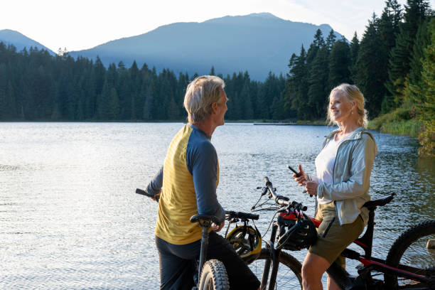 istock Mountain biking couple pause on lakeshore 2174735395